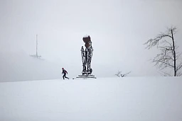 Trains d'orientation dans la neige fraîche, le sommet de la tour radio d'Ulmizberg dépasse du brouillard.