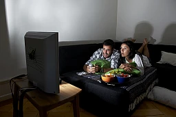 Series junkies couple in front of the TV