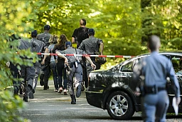 Police cadets run in search of clues at the entrance to the Bois d'Avault