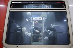 A border guard checks passengers in a train compartment of the Thello night train at Brig station. A border guard checks passengers in a train compartment of the Thello night train at Brig station.