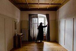 Prioress Irene Gassmann opens the curtain in a cell. Prioress Irene Gassmann opens the curtain in a cell.