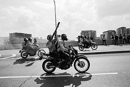 A group of motorcyclists police throwing tear gas bomb to a group of protestors, Caracas 2017.