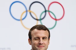 French President Emmanuel Macron winks during a press conference after the presentation of Paris 2024 Candidate City Briefing for International Olympic Committee (IOC) Members, at the SwissTech Convention Centre, in Lausanne, Switzerland, Tuesday, July 11, 2017.