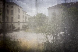 During the course of a year-long project about bipolar disorder, I shot in many different situations and with a good number of patients, healthcare providers, and relatives. For this image, I was embedded in the team of the emergency ward of a very large psychiatry hospital. This unit was closed and some patients denied the right to go out, often for their own safety. During that time, patients have only one horizon: the courtyard, here shielded from view by a curtain that was drawn on the open window. In addition to this literal locked-in, patients having the disease are often locked into their own world, not entirely in contact with reality as most people would perceive it. This may make it difficult to interact with them. - Zurich, Switzerland, 14 August 2018