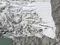 A drone picture shows the Rhone Glacier covered in blankets and the glacial lake above Gletsch near the Furkapass in Switzerland, Wednesday, July 24, 2019. One part of the glacier is protected by special white blankets to prevent it from melting. (KEYSTONE/Peter Klaunzer)