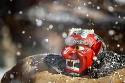 A man dressed with a traditional "straw man" costume and devil mask parades during the carnival through the alpine village of Evolene, Switzerland, Sunday, March 3, 2019. The straw men, so-called "empailles" in French, stuffed with up to 30kg of straw, represent the spirit of the ancestors and deceased believed to haunt the region. (KEYSTONE/Valentin Flauraud)