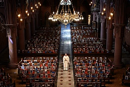 Abbot Vincent Marville poses on May 3, 2020 after a behind closed door mass in the central aisle of the Basilica of Neuchatel which displays the portraits of 400 parishioners unable to attend the mass due to the COVID-19 outbreak, caused by the novel coronavirus. Abbot Vincent Marville poses on May 3, 2020 after a behind closed door mass in the central aisle of the Basilica of Neuchatel which displays the portraits of 400 parishioners unable to attend the mass due to the COVID-19 outbreak, caused by the novel coronavirus.