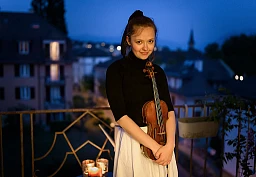 Moldavian virtuoso violist Alexandra Conunova poses after playing a concert from her balcony for her neighbours on April 24, 2020 in Lausanne during the semi-lockdown due to the Covid-19.