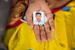 Suvarna Thadakapalli (23) Holding photograph of her dead husband
