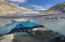Glaciologist at ETHZ and head of the Glacier Monitoring in Switzerland (GLAMOS) Matthias Huss enters an ice cave at the tongue of the Rhone glacier amid climate change in Obergoms, Switzerland, August 27, 2024