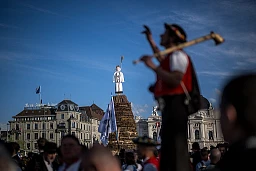 People wearing traditional clothing from the Swiss Canton of Appenzell stand next to the snowman prepared with explosives, known as the "Boogg", that was not set on fire due to strong winds during the Sechseläuten, the traditional spring holiday, in Zurich, on April 15, 2024. People wearing traditional clothing from the Swiss Canton of Appenzell stand next to the snowman prepared with explosives, known as the "Boogg", that was not set on fire due to strong winds during the Sechseläuten, the traditional spring holiday, in Zurich, on April 15, 2024.